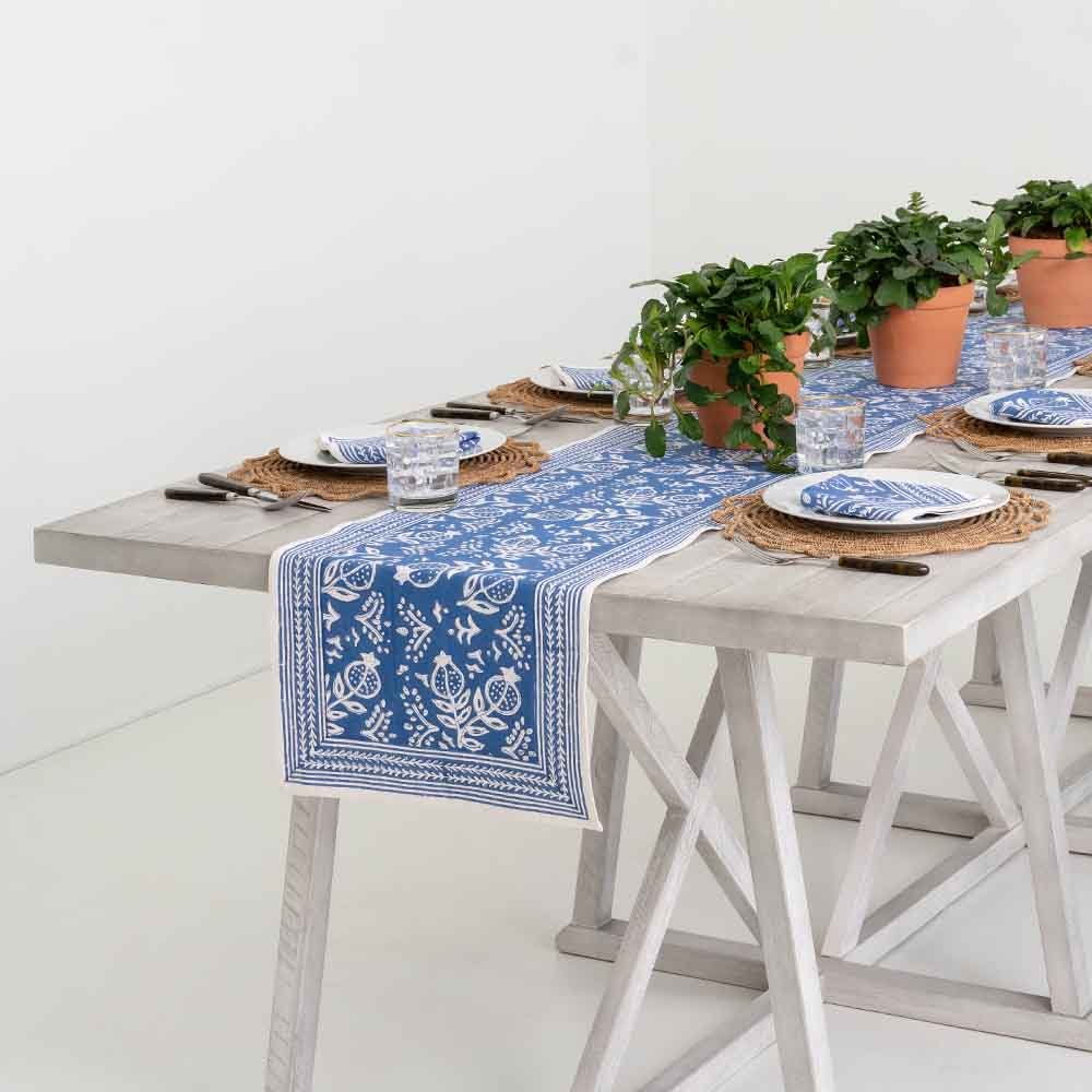 Pomegranate Blue table runner with matching napkins and plants. 