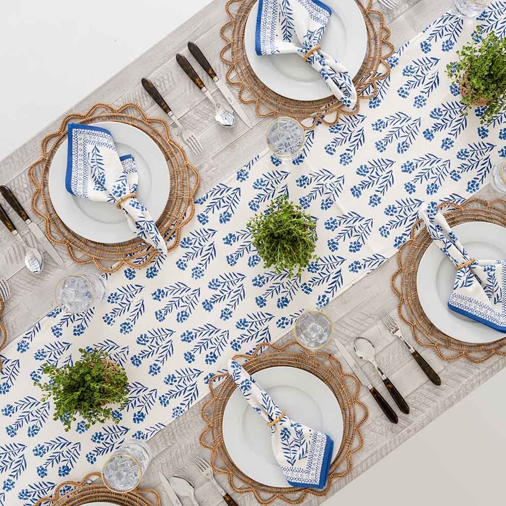 Overhead shot of dinner table decorated with Phlox Blue textiles. 