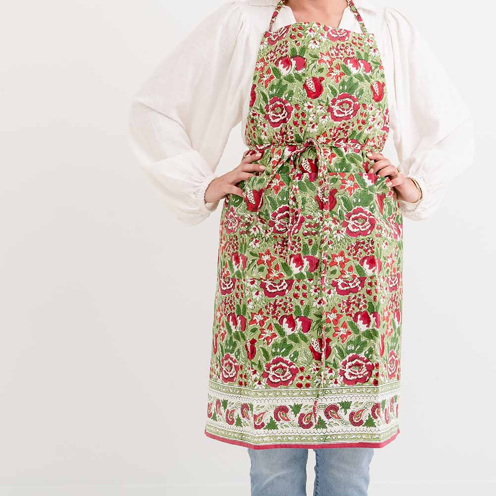 Apron designed in a tossed floral print with hues of raspberry, moss, and fern. 