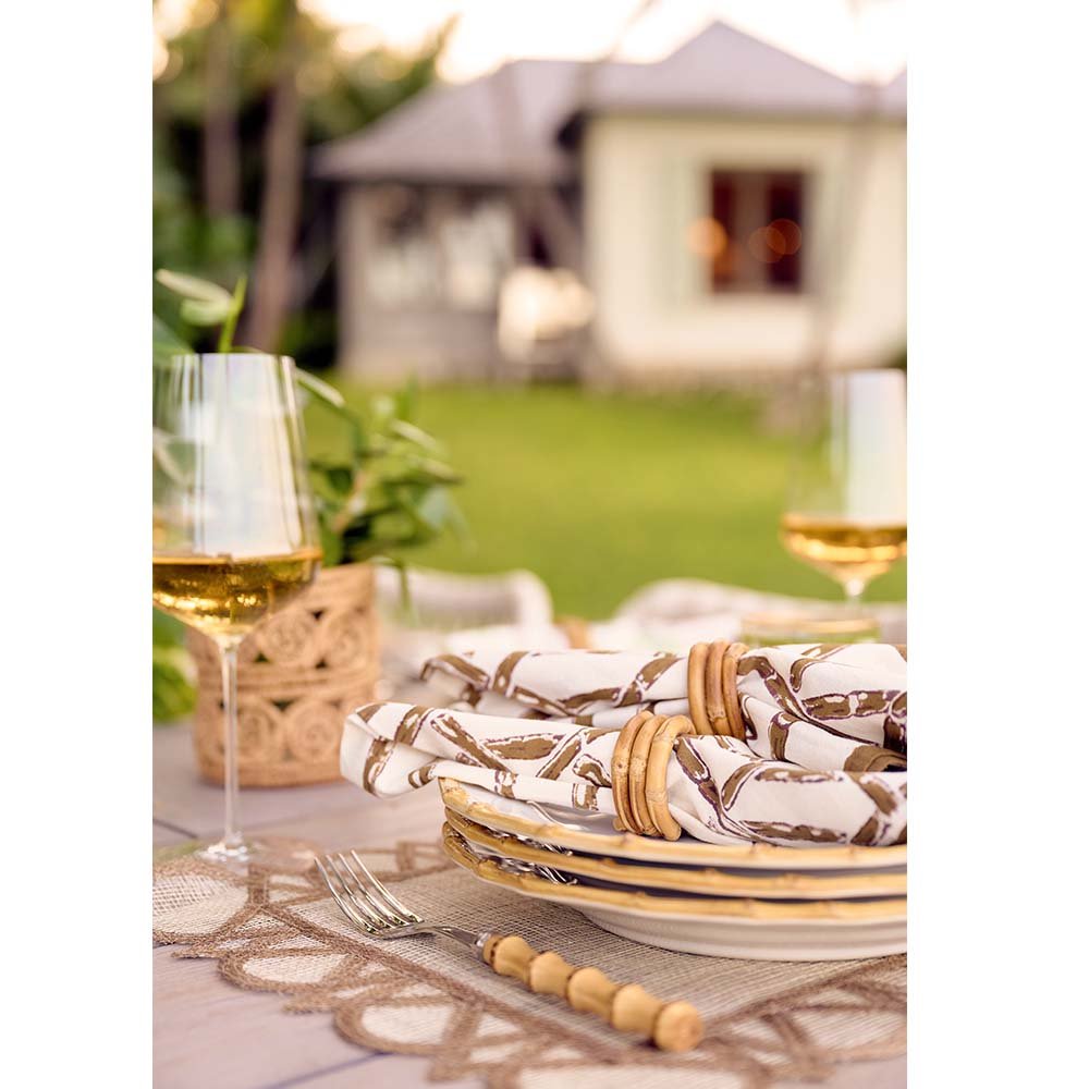 Brown Bamboo napkins on an outdoor dinner table, aesthetically paired with white wine. 