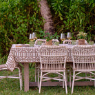 An outdoor dinner table decorated with the elegant Brown Bamboo tablecloth. 
