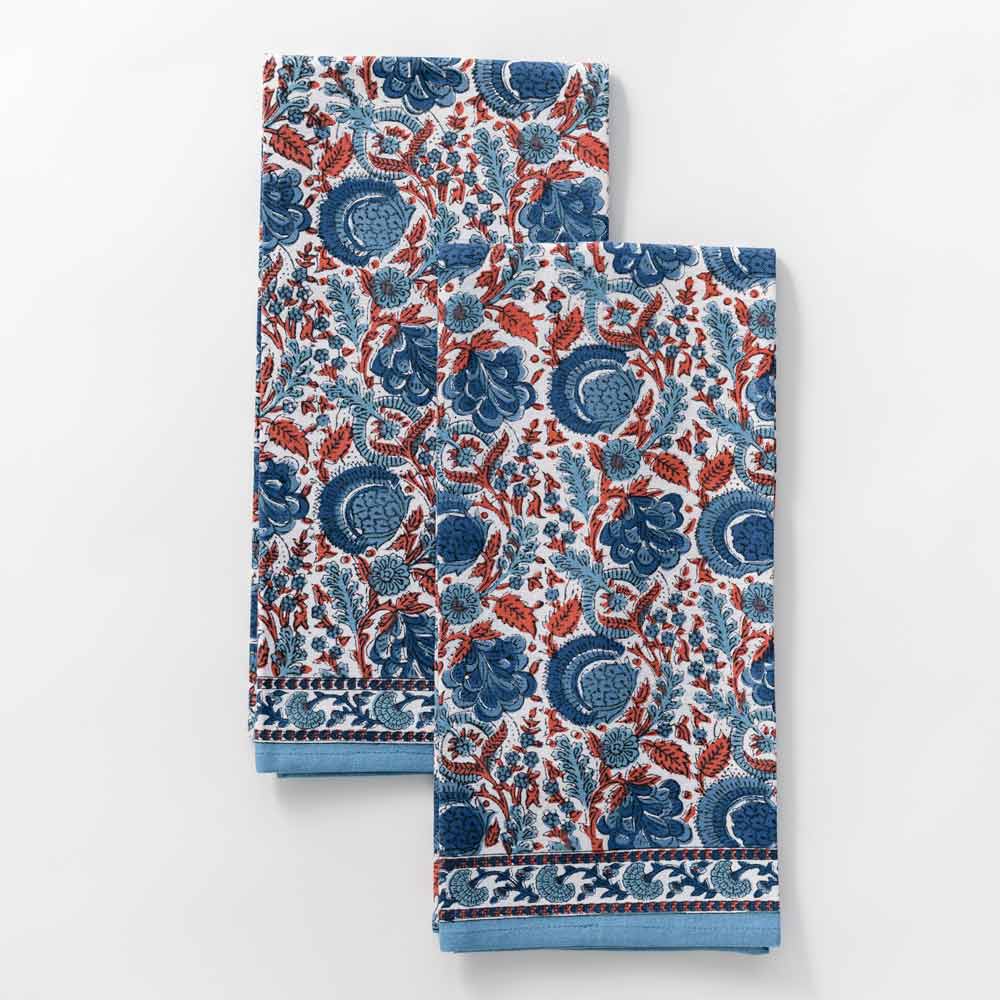 Tea towel designed in hues of blue and paprika orange as a floral hand blocked cotton print. 