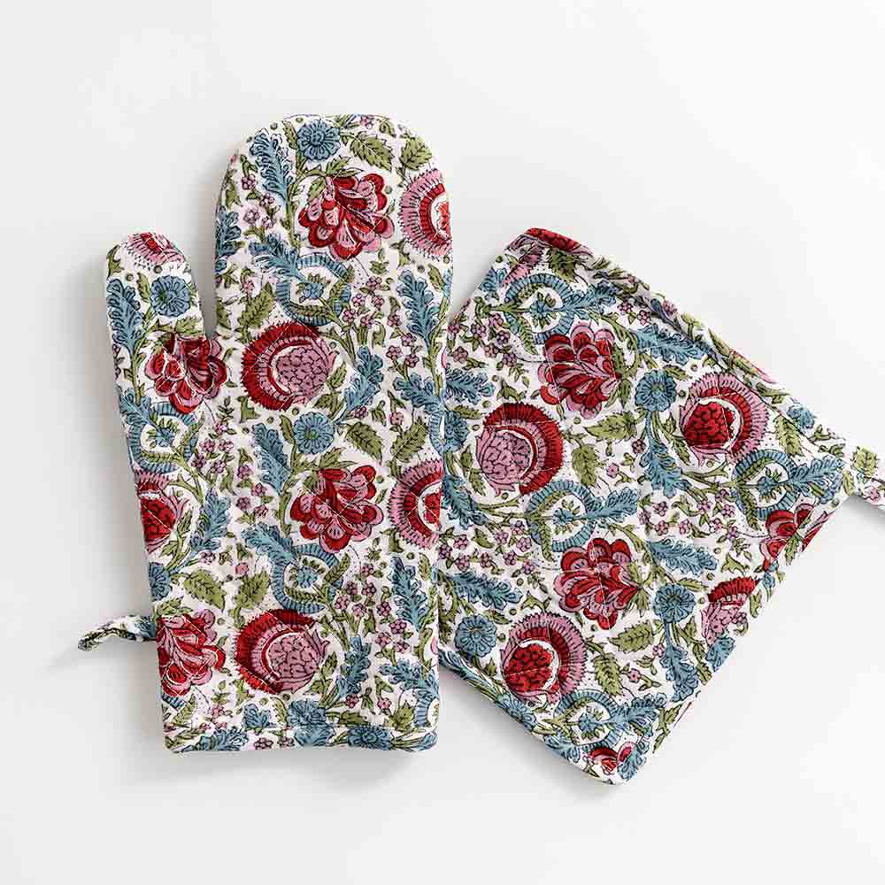 Oven mitt designed in turquoise, cranberry red, pink, and aqua as a floral hand blocked cotton print. 