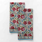 Tea towels designed in turquoise, cranberry red, pink, and aqua as a floral hand blocked cotton print. 