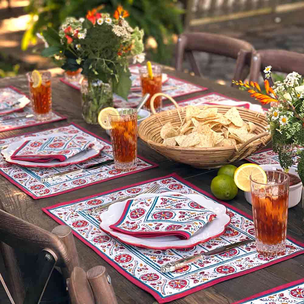 Bukhara Stripe Brick & Teal Placemat on table with flowers and iced tea
