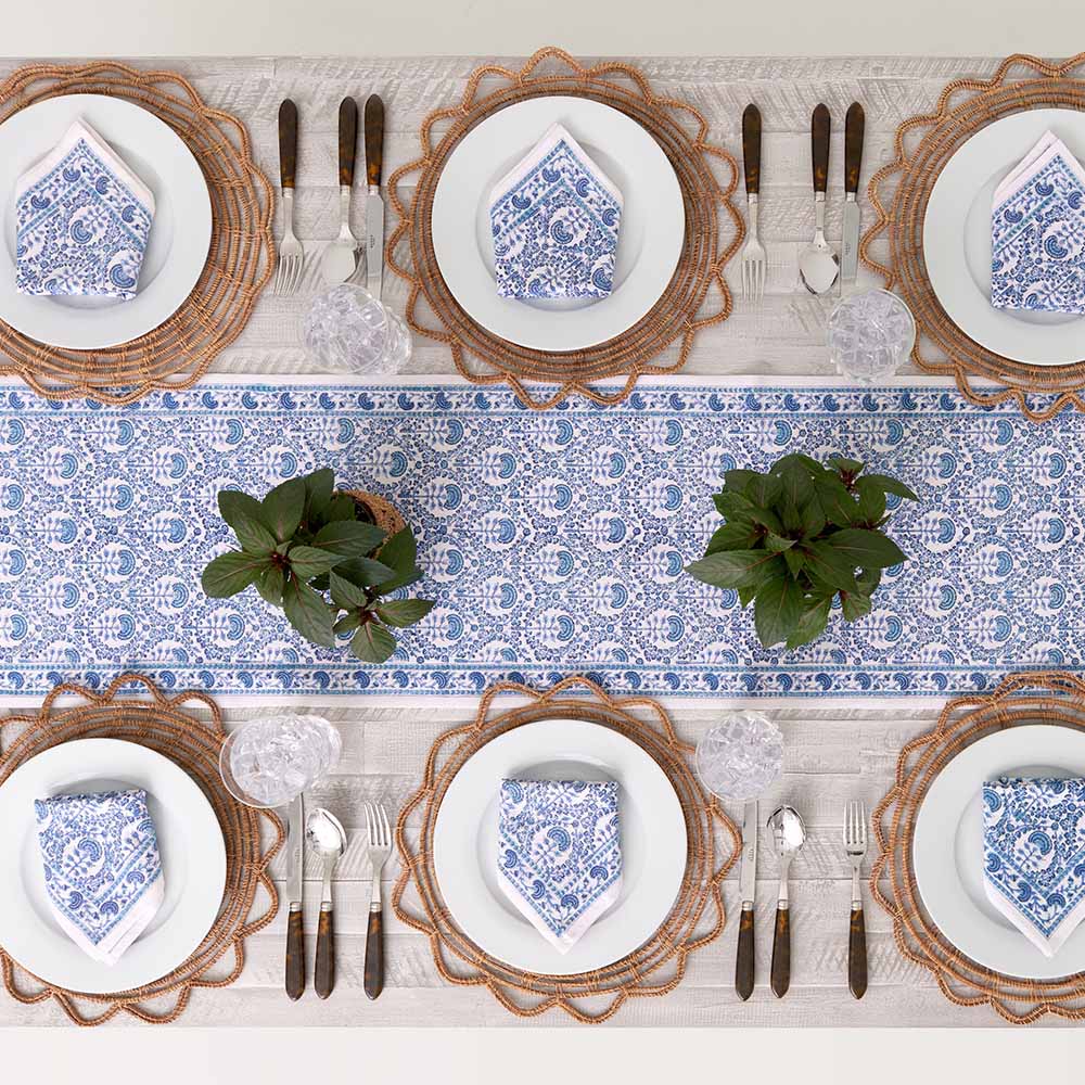 Table runner paired with matching napkins decorating dinner table. 