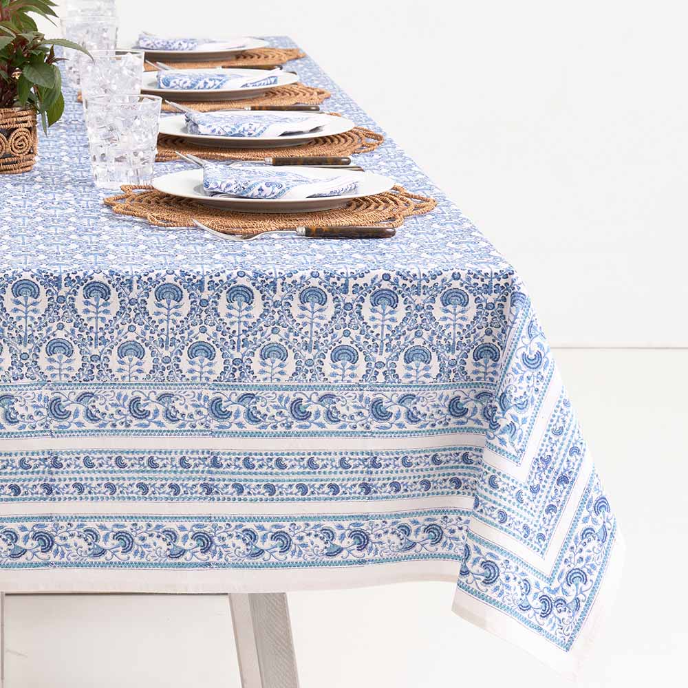 Warm hues of mixed blues paired with the intricate white details make this tablecloth stand out. 