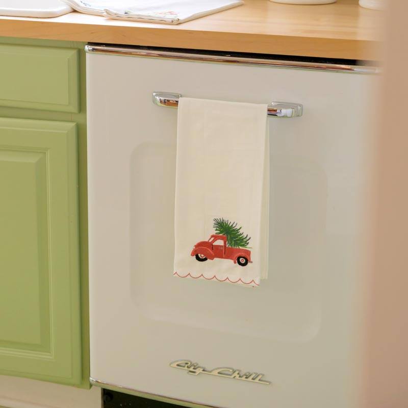 Red Christmas Truck Tea Towel hanging on dishwasher