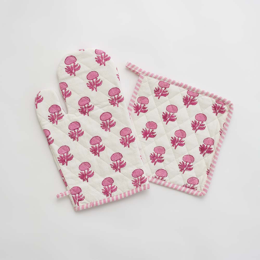Pink and white oven mitt and pot holder set. 
