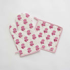 Pink and white oven mitt and pot holder set. 