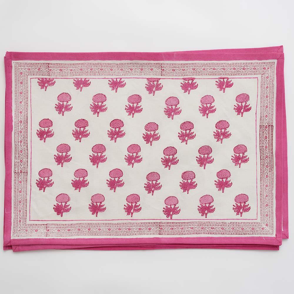 Pink and white floral print placemat with pink border outline. 