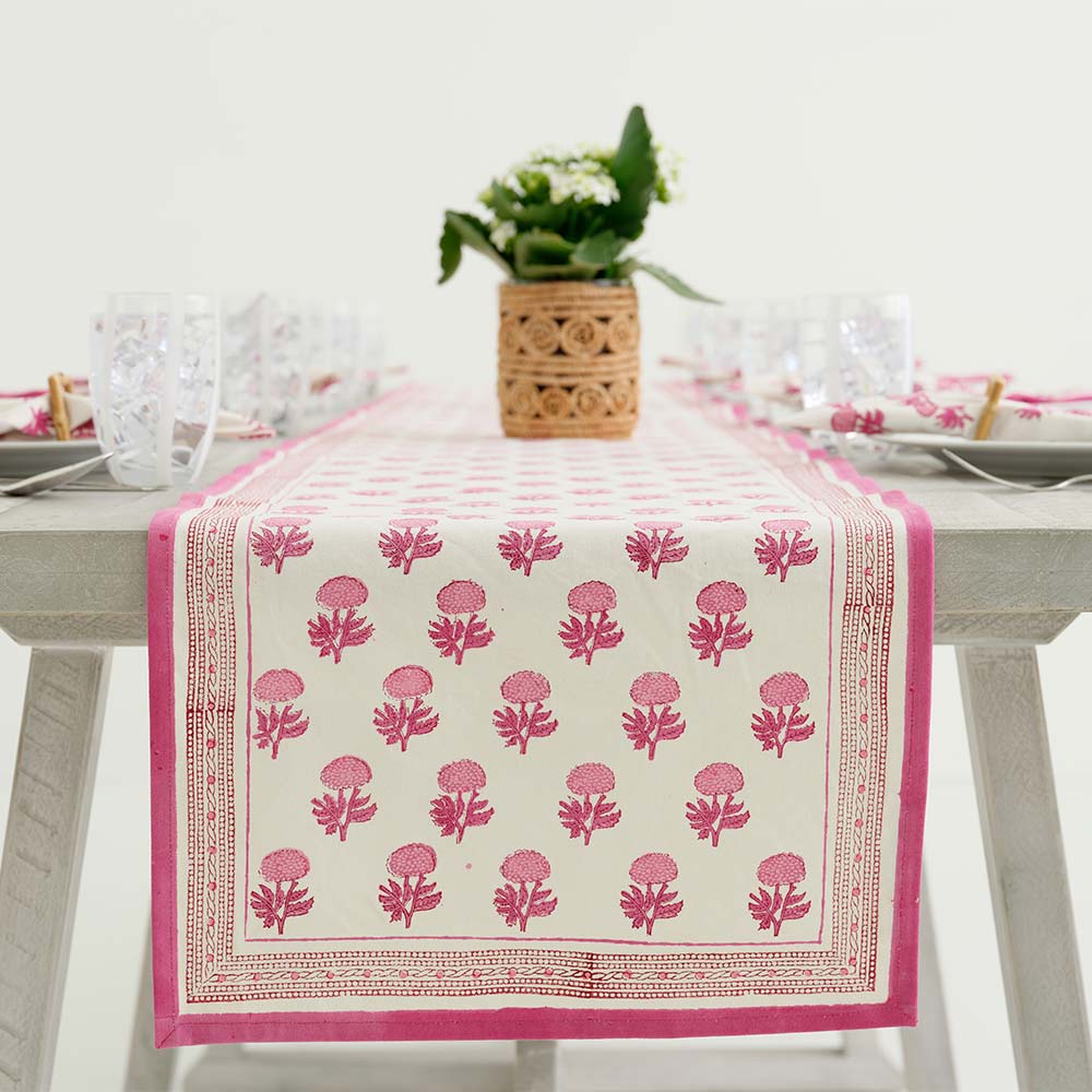 Table runner hanging off of side of table. 