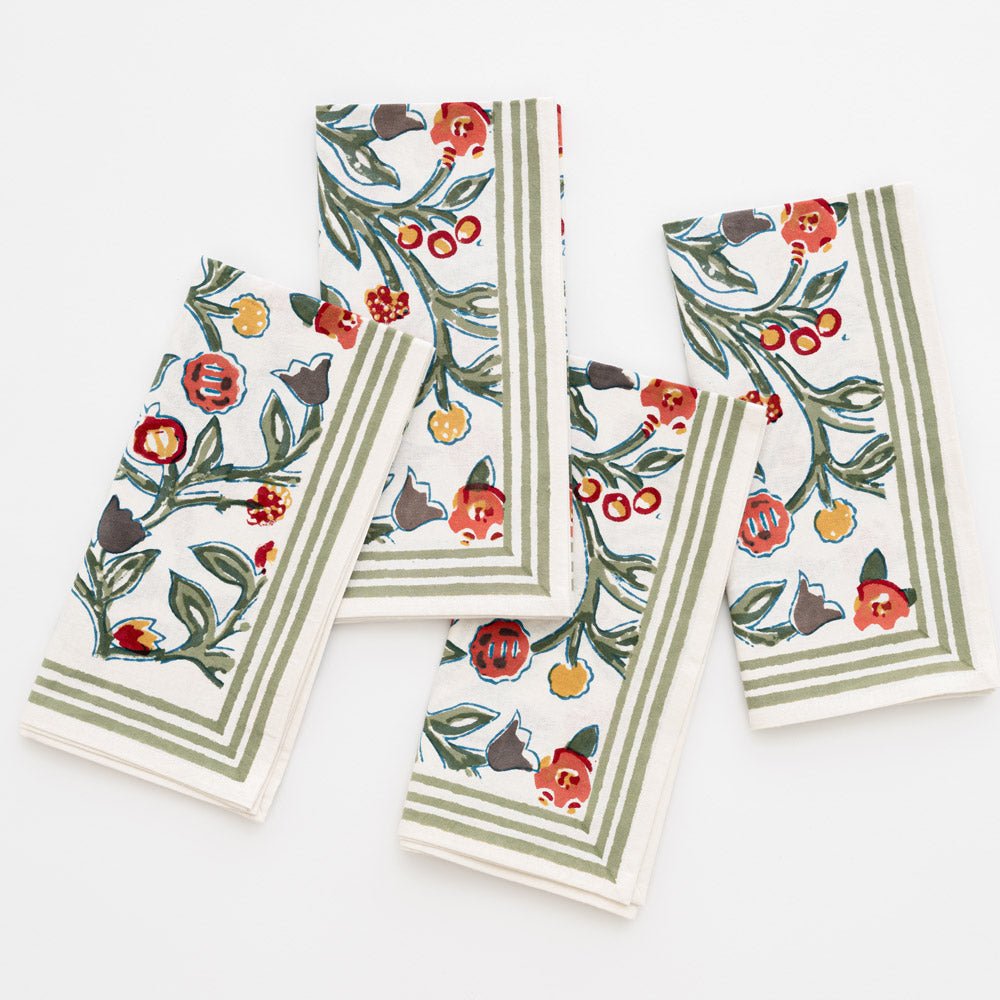 4 napkins folded as rectangles with floral pattern in shades of sage green, crimson, marigold and deep orange