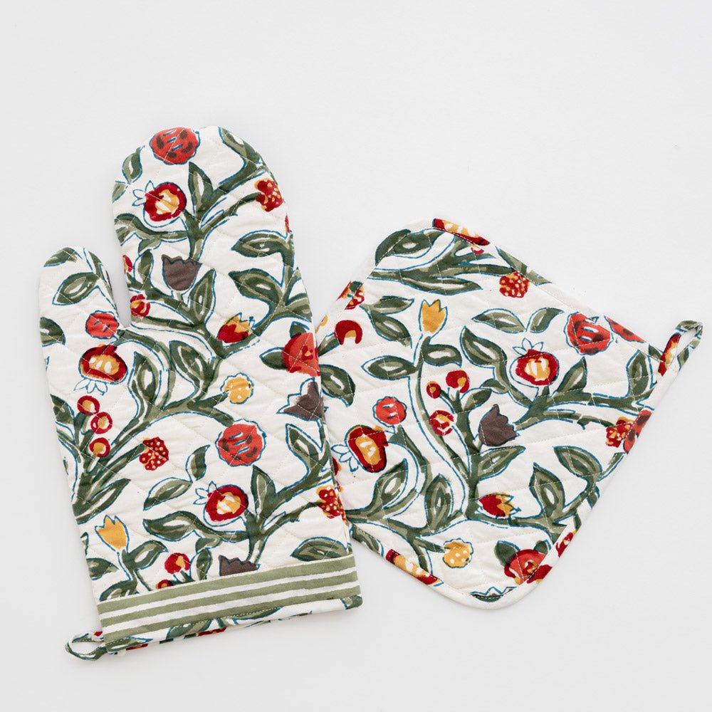 oven mitt and pot holder set with floral pattern in shades of sage green, crimson, marigold and deep orange on a white background