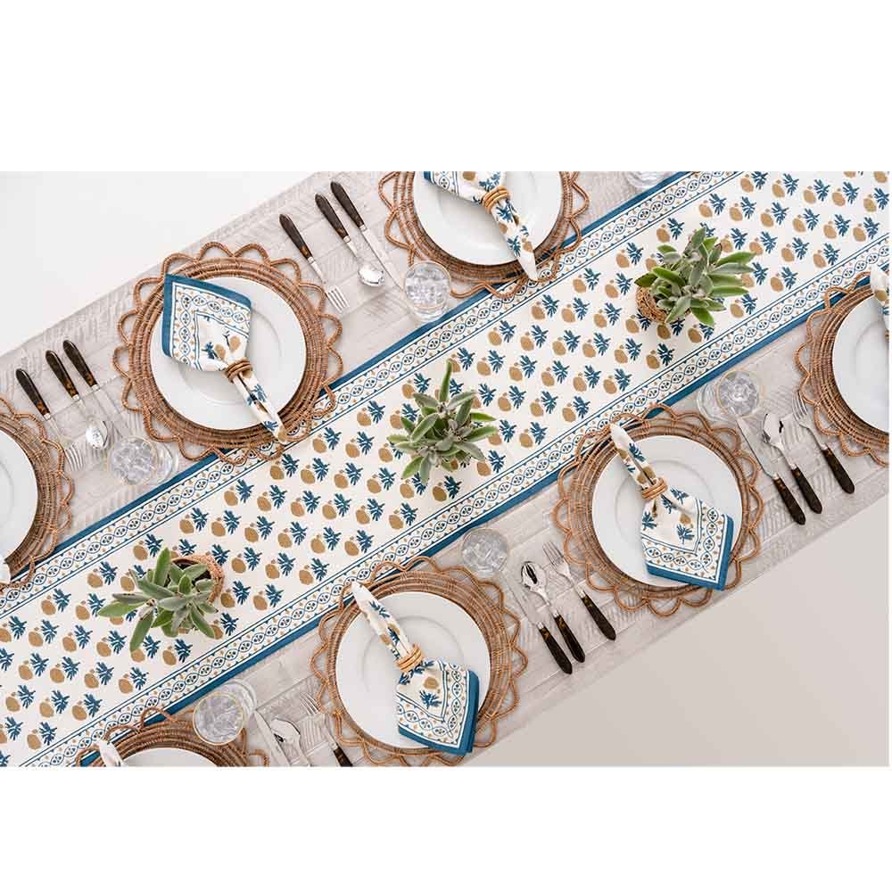 Overhead shot of dinner table with table runner and matching napkins. 