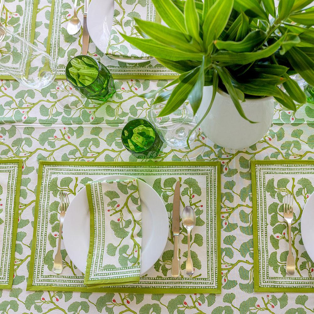 Spring Ginkgo Napkins with plant and green glasses.