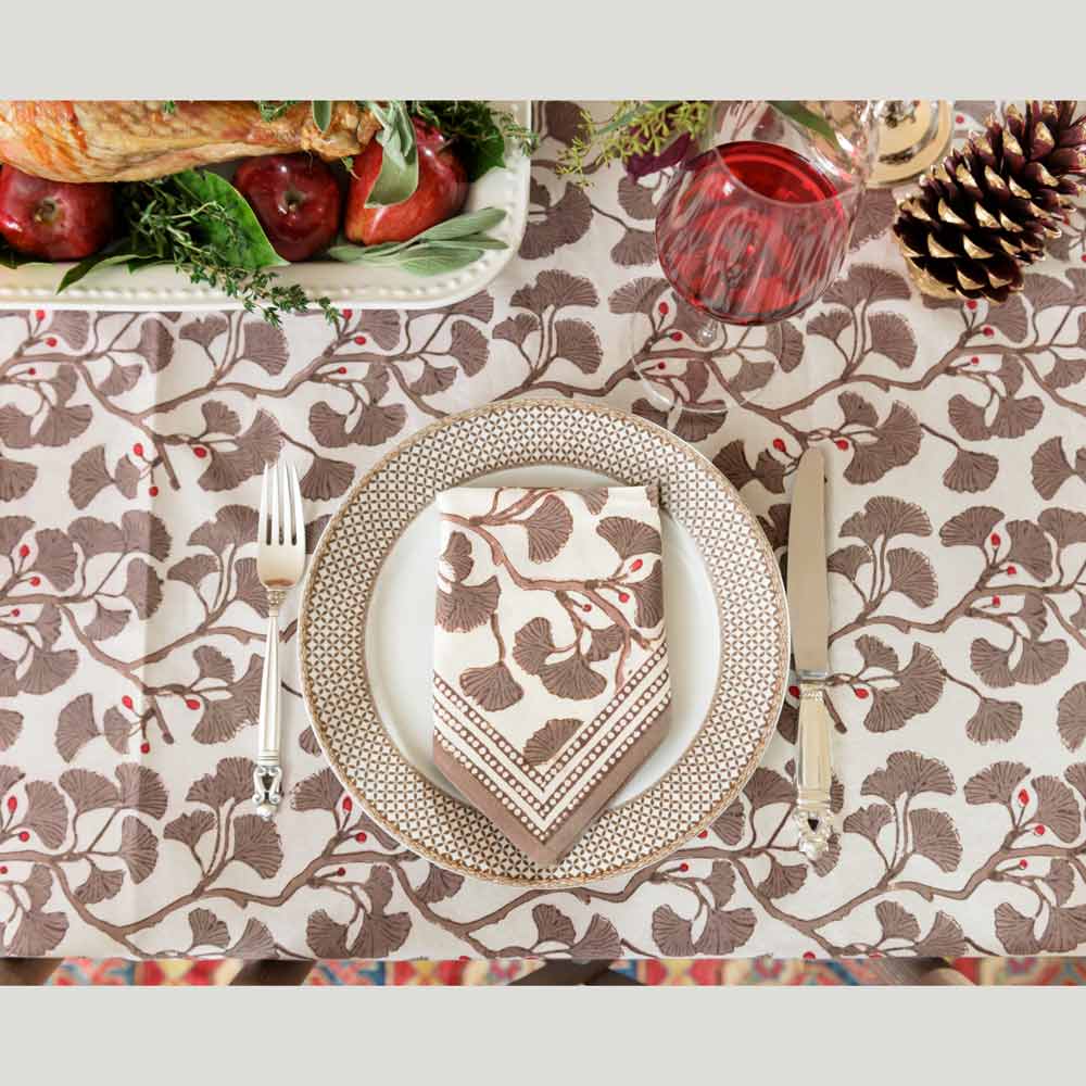 Ginkgo Taupe napkin and matching tablecloth on fall dinner table. 