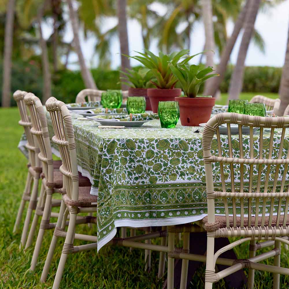 Jade Blossom tablecloth on outdoor table in tropical setting. 