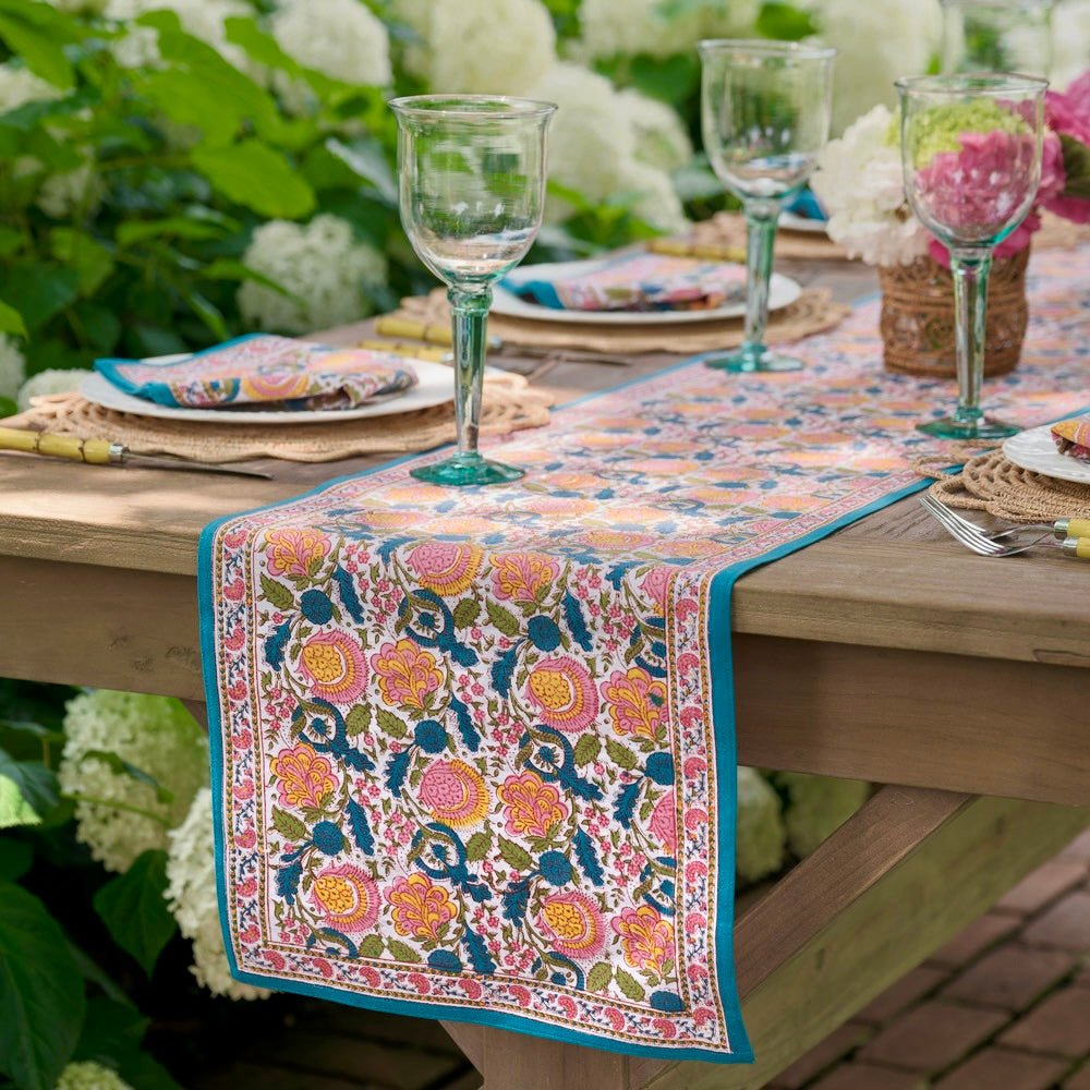 Jewel tone colored table runner with blossom design.