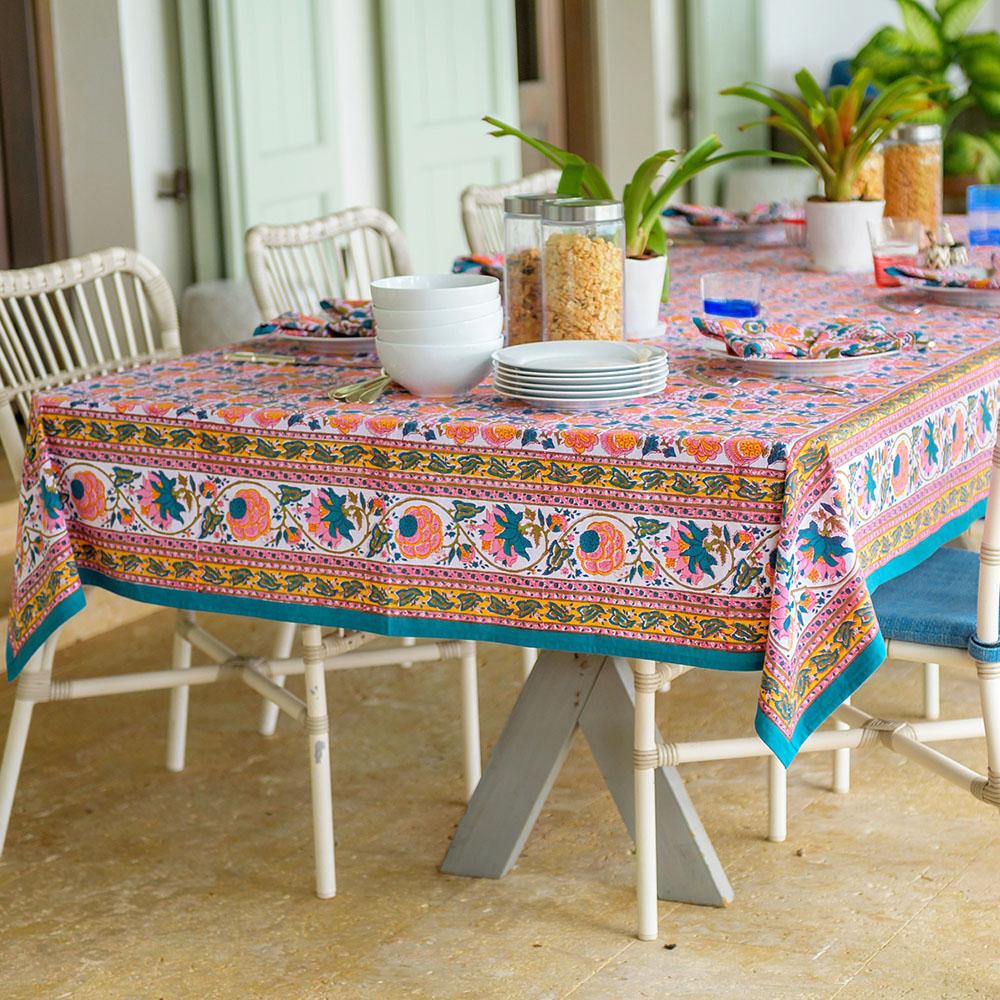 Jewel Blossom Tablecloth on a white table with dishes and plants.