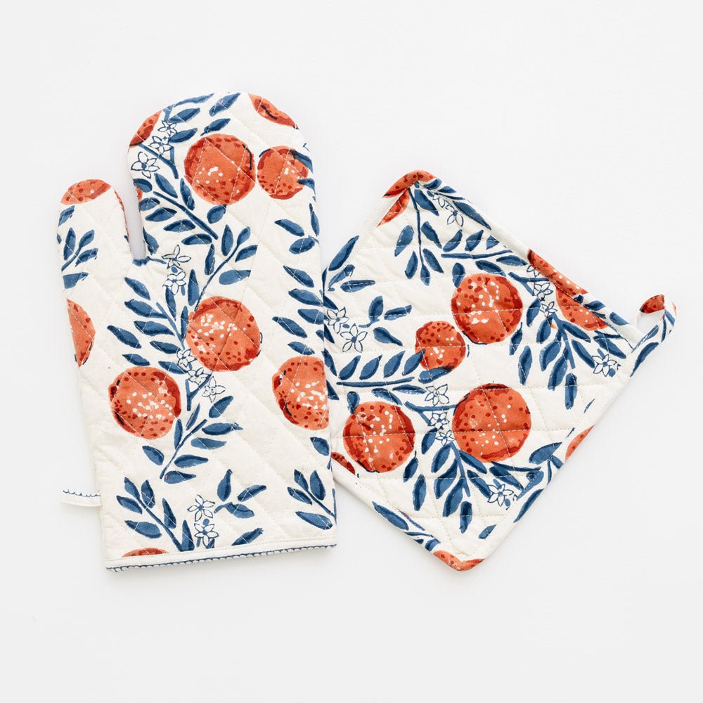 white oven mitt and potholder with blue vines and oranges