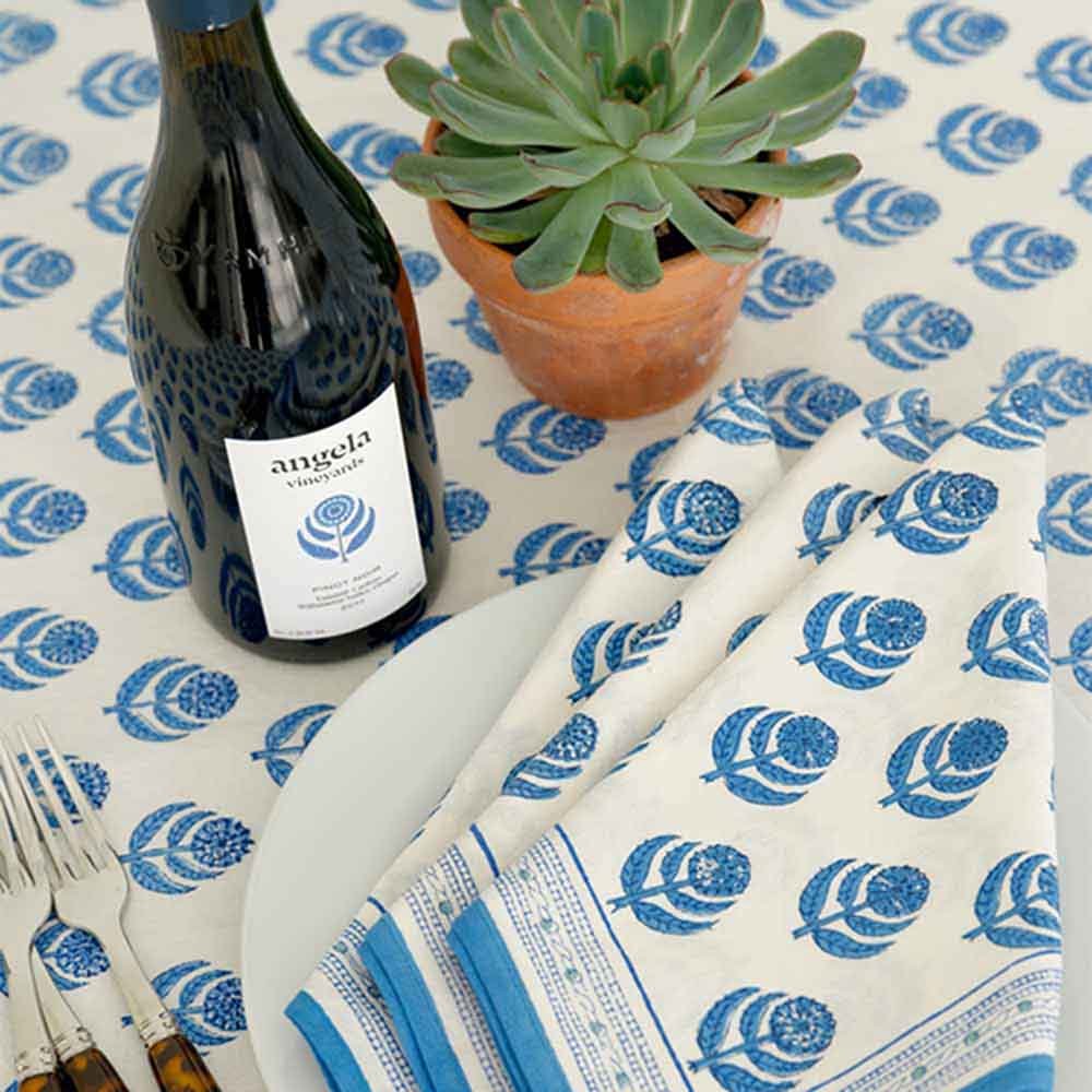 Close up of Pinot tablecloth, matching napkins, and wine. 