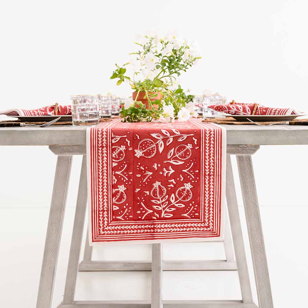 Table runner hanging off side of table. 