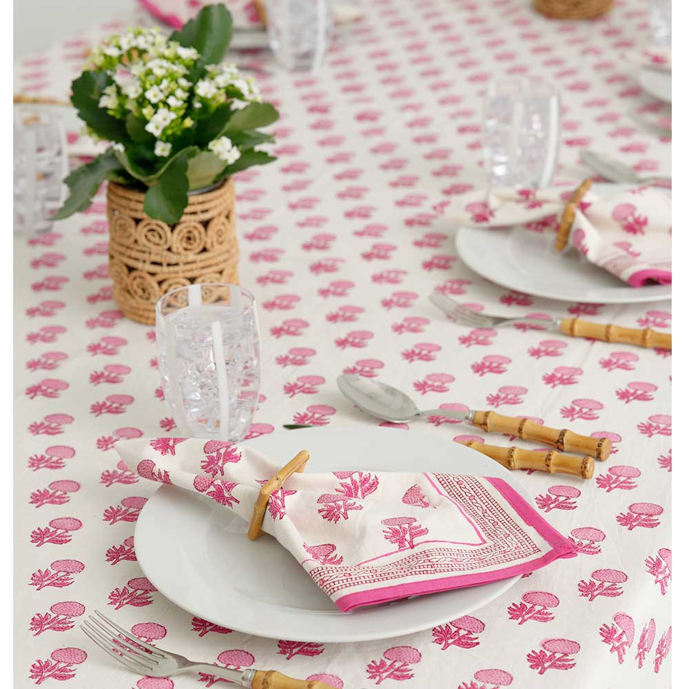 Close up of rosé tablecloth and matching napkin. 