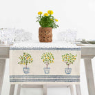 Table runner and yellow flowers. 