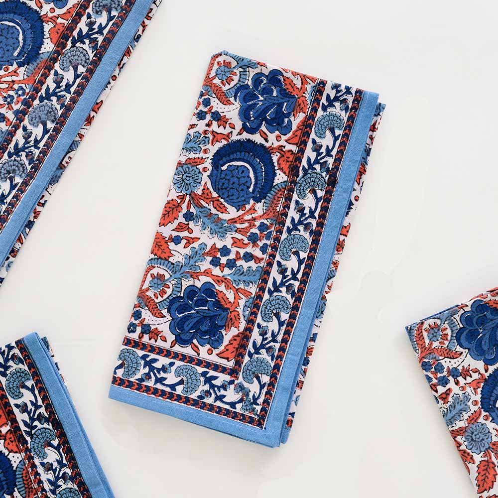 Hand block printed napkin with hues of blue and paprika orange. 