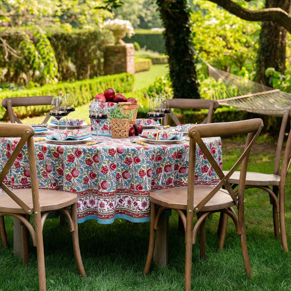 Bohemian tablecloth displaying turquoise, cranberry red, pink, and aqua hues. 