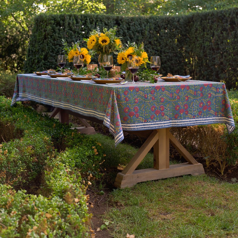 Cactus Flower Midnight Dark Blue & Magenta Floral Tablecloth outdoors set with yellow plates and sunflowers