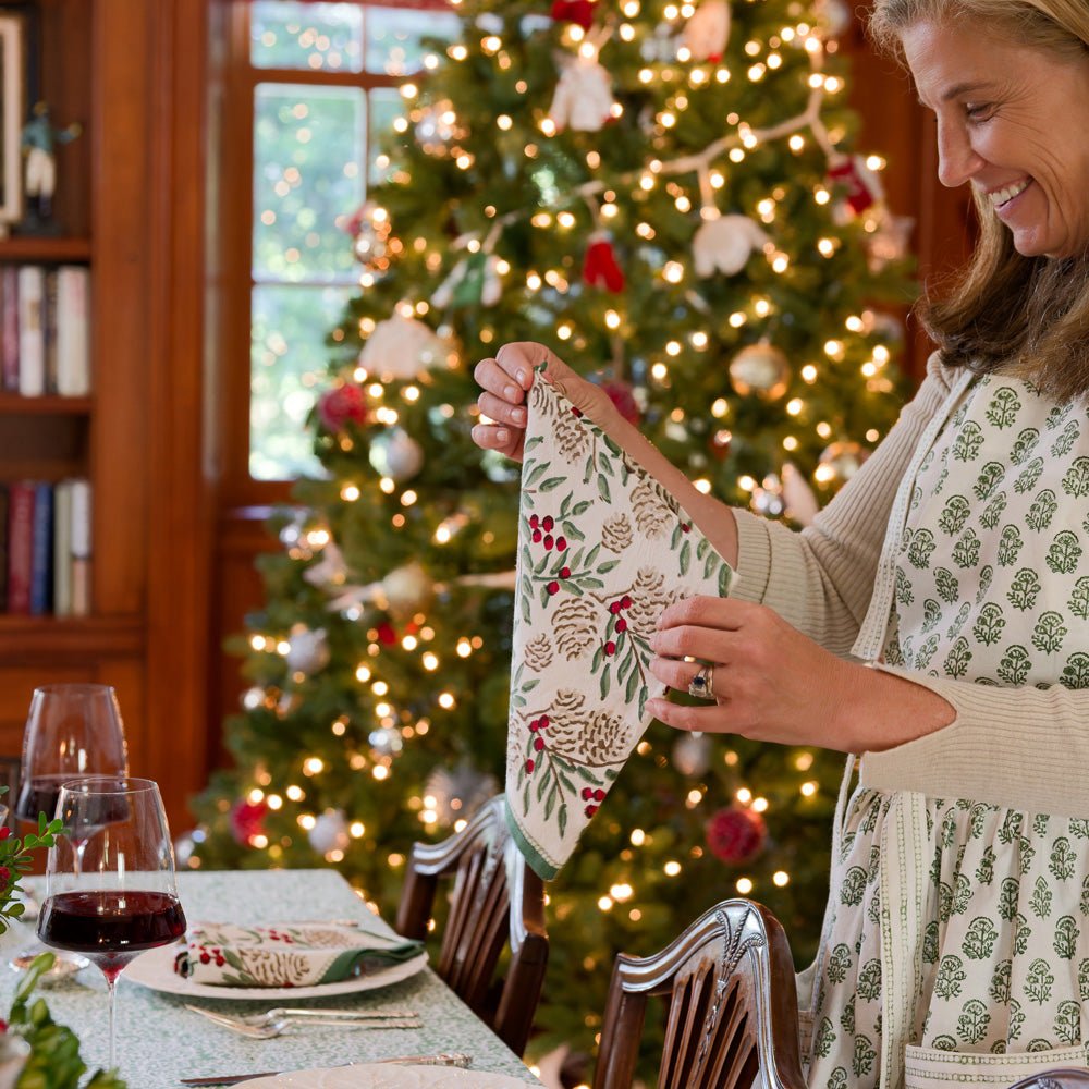 model wearing christmas garland apron and folding matching napkin