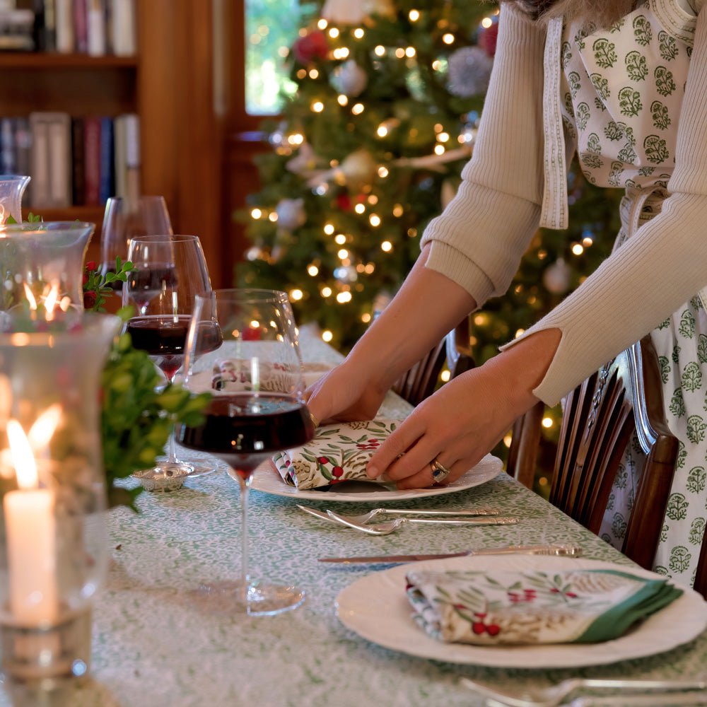 woman placing Christmas Garland Napkin on table