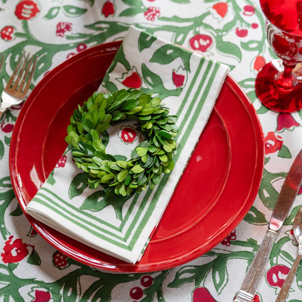 emma red & green napkin on red plate with mini wreath