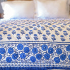 Gaya Cobalt Blue & White floral hand block printed quilt on bed