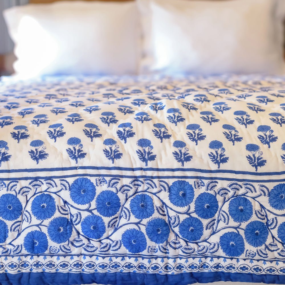 Gaya Cobalt Blue &amp; White floral hand block printed quilt on bed