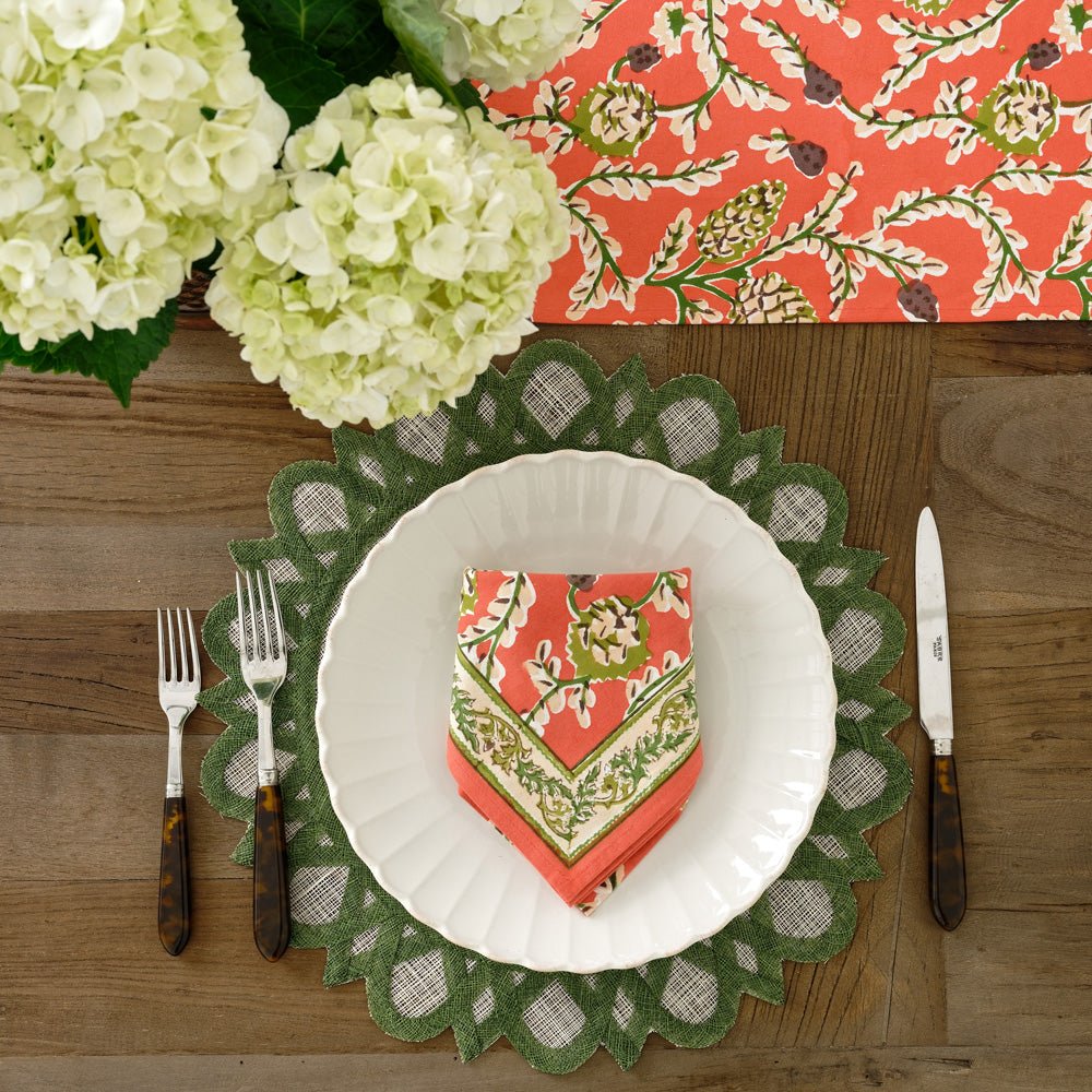 Harvest pinecone napkin on white plate and green starburst rice paper placemat
