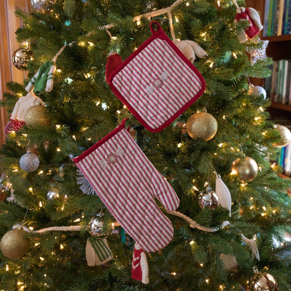 Embroidered peppermint red &amp; white stripe oven mitt and pot holder set hanging from christmas tree