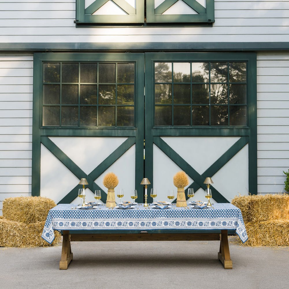 outdoor table with pom buti denim tablecloth and matching napkins