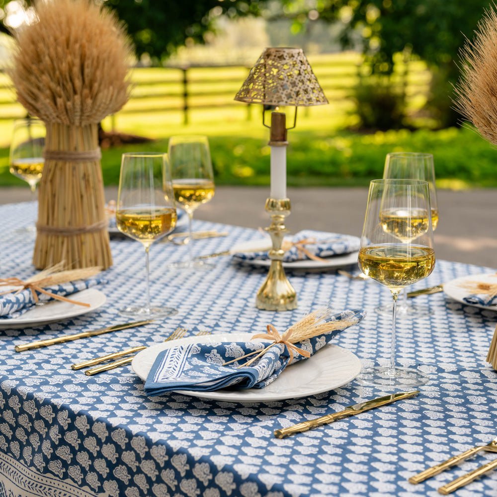 outdoor table with pom buti denim tablecloth and matching napkins
