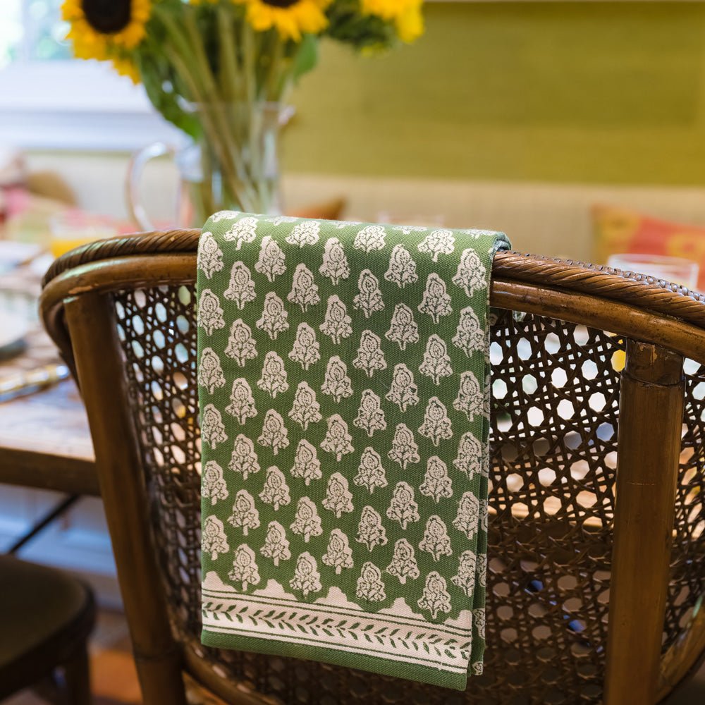 Pom Buti Green &amp; White Floral Tea Towel hanging over back of chair