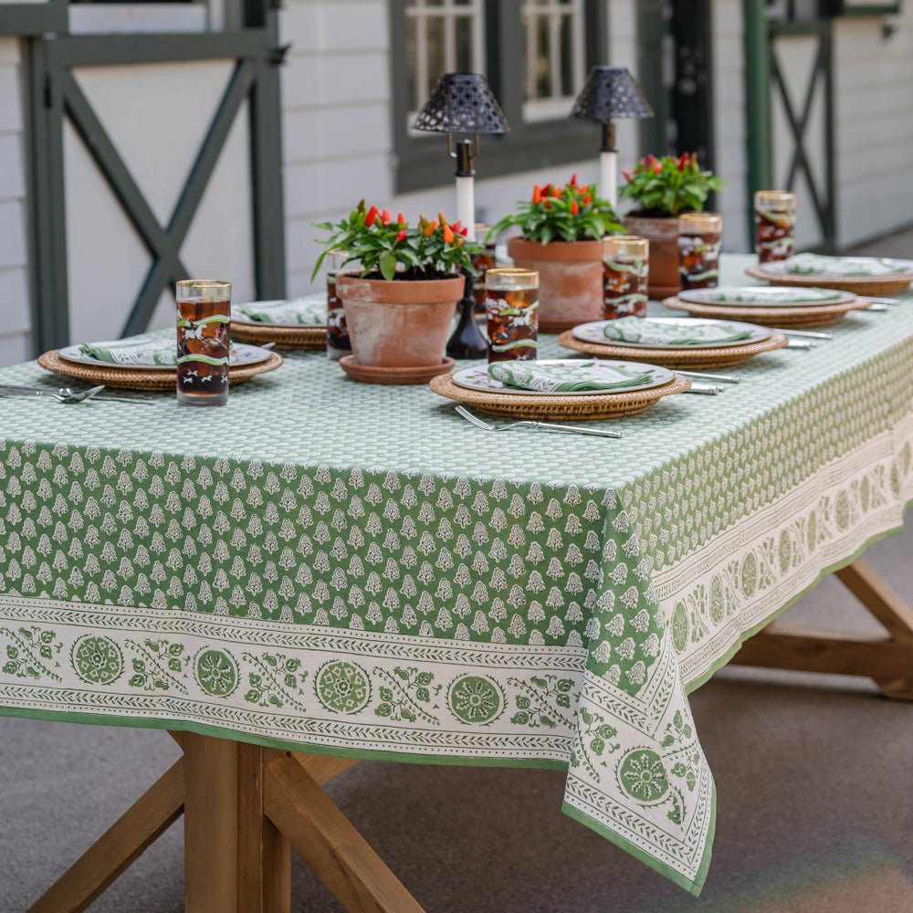 Outdoor table with pom buti green tablecloth
