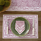 Tapestry eggplant purple & white napkin on green plate and matching placemat