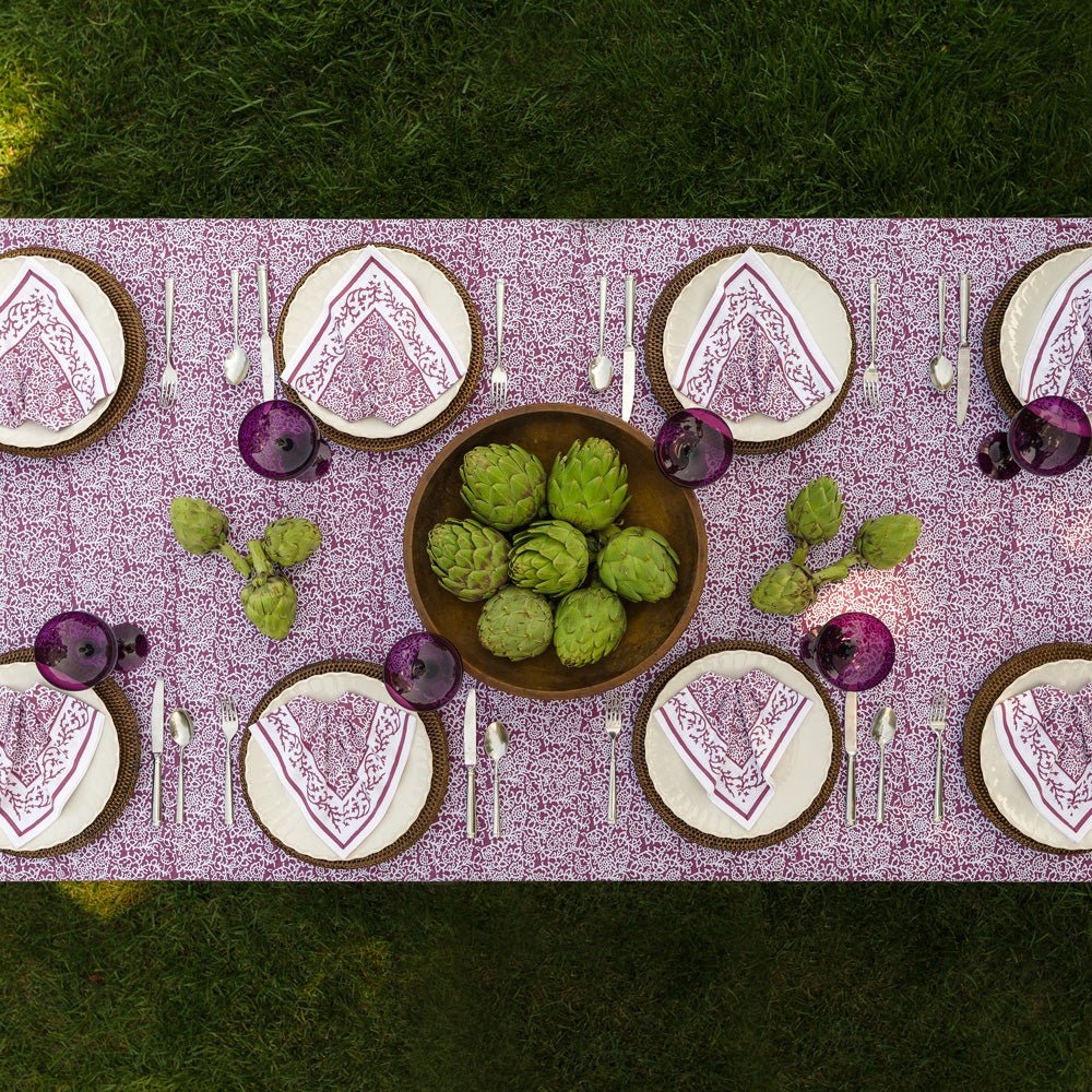 overhead view of Tapestry eggplant purple & white tablecloth with matching napkins