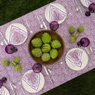 overhead view of tapestry eggplant purple and white tablecloth with matching napkins