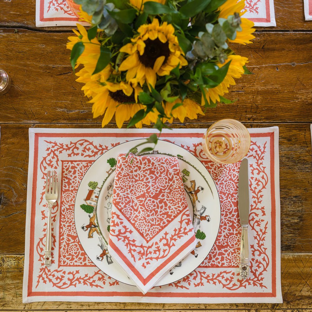 Tapestry Persimmon Placemat with matching napkin on table with sunflowers