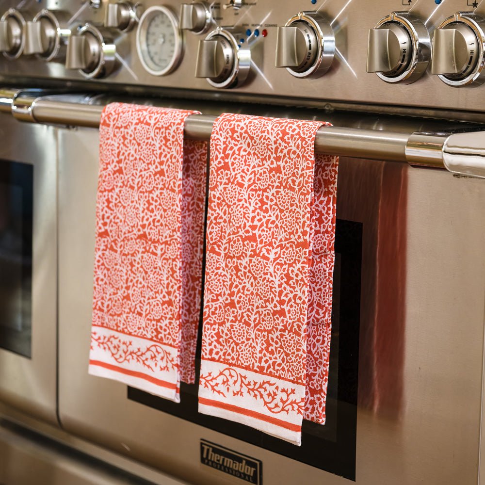 Tapestry Persimmon Tea Towels hanging from stove handle