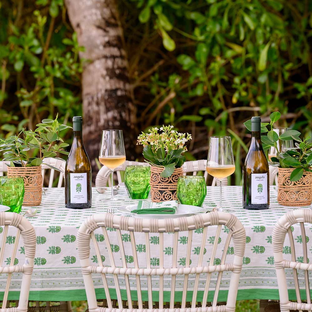 Outdoor dinner table pairs the tablecloth with its signature wine. 