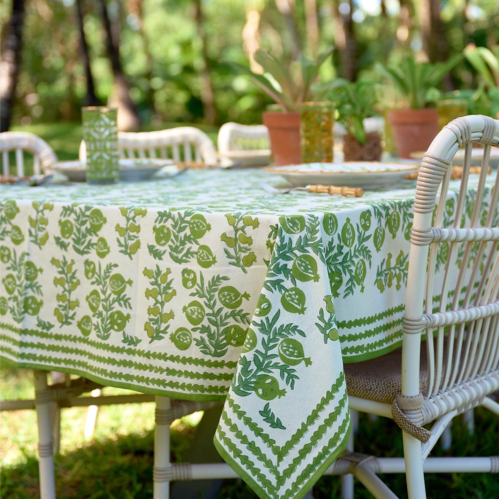 Outdoor table with close up of green and white design. 